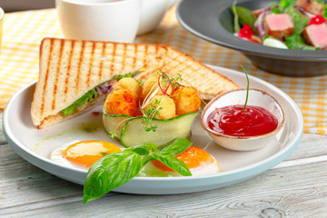 Club sandwich panini with ham, tomato, cheese and basil with cheese balls