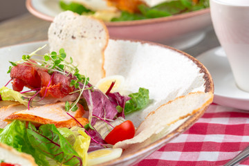 Fresh salad with chicken breast, arugula and tomato. Top view