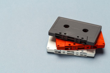 Bright retro cassette tapes on a light grey background