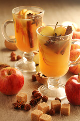 Two cups with hot cider in cold season with cinnamon and anise