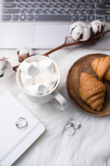 Cozy winter bloggers white work space with laptop, coffee with m