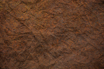 darkness theme. dark background and wallpaper or texture of brown paper old and crumpled have a stain like stain rust metal.