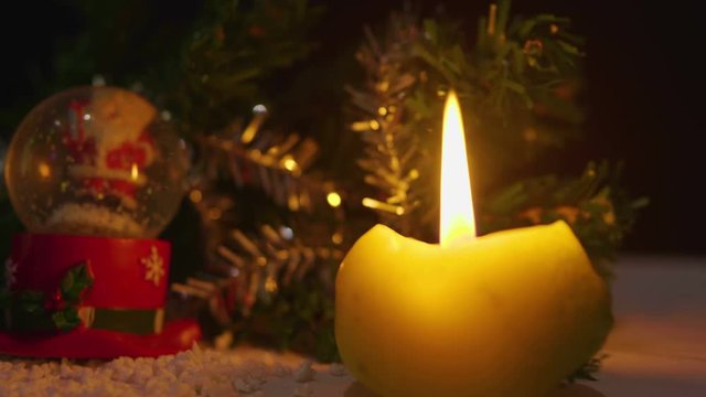 Animation of candles burning and snow globe for Christmas day