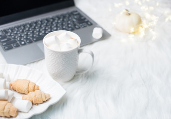 Obraz na płótnie Canvas Cozy winter bloggers white work space with laptop, coffee with m