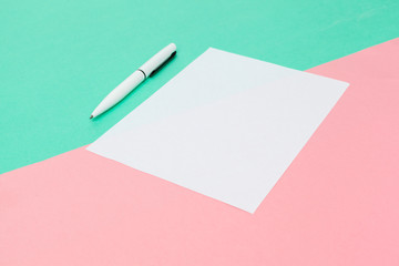 White paper notepad on pastel color background.Flat lay design.