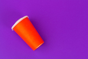 Takeaway cup of coffee on bright colored background