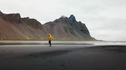 a young man wearing a yellow jacket in hofn