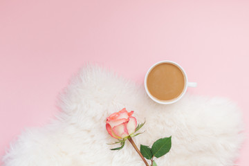 Cup of coffee and rose flower on pink background