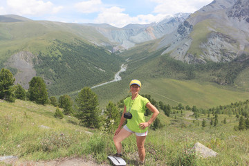 Tourist woman standing on Pass Kara-Turek, View of the gorge Yarlu, Altai Mountains, Russia