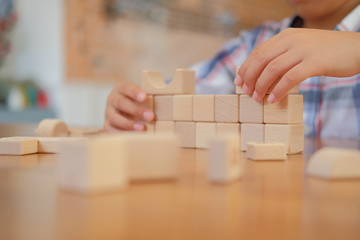 little asian kid boy child children schoolboy playing wood block toy. learning education concept