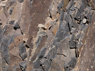 Stone texture with shallow and deep cracks. Rock mineral pattern closeup.