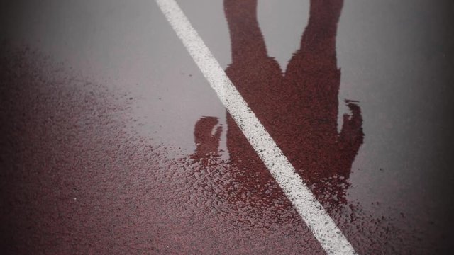 Shot of Athlete Man Reflection on the Rain Water Swamp at the Stadium