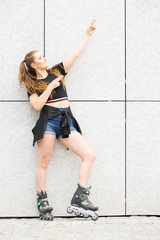 Young woman riding roller skates