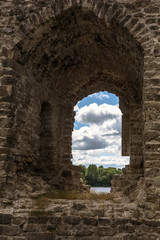 River and clouds through ruins of Koknese Castle - one of the largest medieval castles in Latvia. Construction of hydroelectric dam in 1965 partially submerged the castle and surrounding valley.