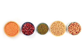 Various types of legumes, shot from above on a white background with copy space. Different beans,...