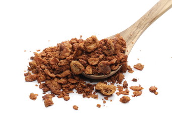 Pork cracklings in wooden spoon isolated on white background