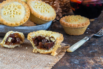 Traditional Christmas mince pies and mulled wine on wooden table