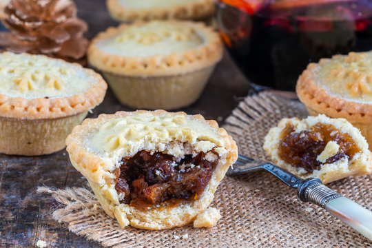Traditional Christmas mince pies and mulled wine on wooden table
