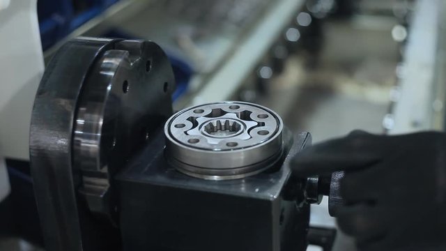 Worker installing rubber gaskets into industrial unit. Manufacturing process