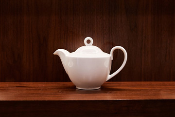 Picture of teapot on wooden table. Overhead view, copy space.
