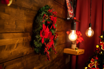 Christmas living room with beautiful christmas wreath on the wall. Beautiful decor.