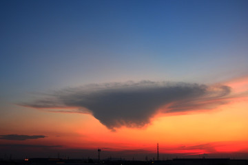 Naklejka premium A strange cloud shape on blue sky background with sunrise