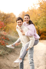 Fototapeta premium Couple in love in the autumn leaves