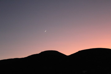 moon and sunset in mountains