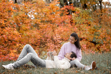 couple in love sitting in autumn park and reading book