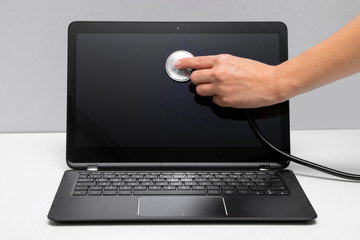 Woman's hand is holding stethoscope on the screen