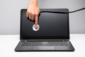 Woman's hand is holding stethoscope on the screen