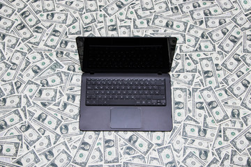 Laptop on dollar bills