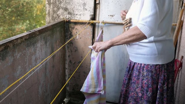 Woman hanging out clothes.