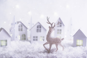 Magical Christmas paper village . Winter background landscape with houses, trees, deer on frosty blue background. Template, greeting card