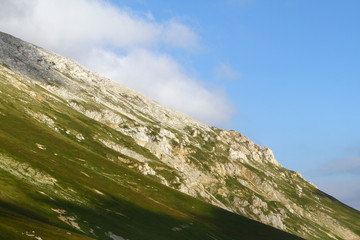 beautiful mountain cliff with bright blue sky, natural landscape photo