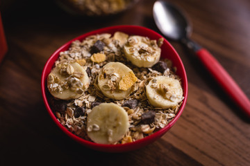 banana with cereals in a red bowl