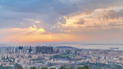 Fototapeta na wymiar Panoramic sunrise view over Lisbon and Almada from a viewpoint in Monsanto morning timelapse.