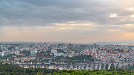 Panoramic view during sunrise over Lisbon and Almada from a viewpoint in Monsanto morning timelapse.