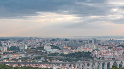 Fototapeta na wymiar Panoramic view during sunrise over Lisbon and Almada from a viewpoint in Monsanto morning timelapse.