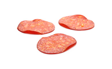 Spicy salami sausage slices isolated on white background