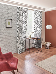 Wooden desk white and brown wall, brick detail and red chair room.