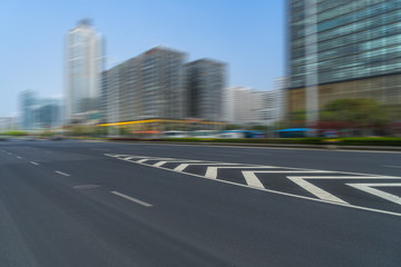 Fototapeta premium city empty traffic road with cityscape in background.