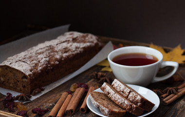 Homemade banana bread with anis star and cinnamon on a dark wooden background