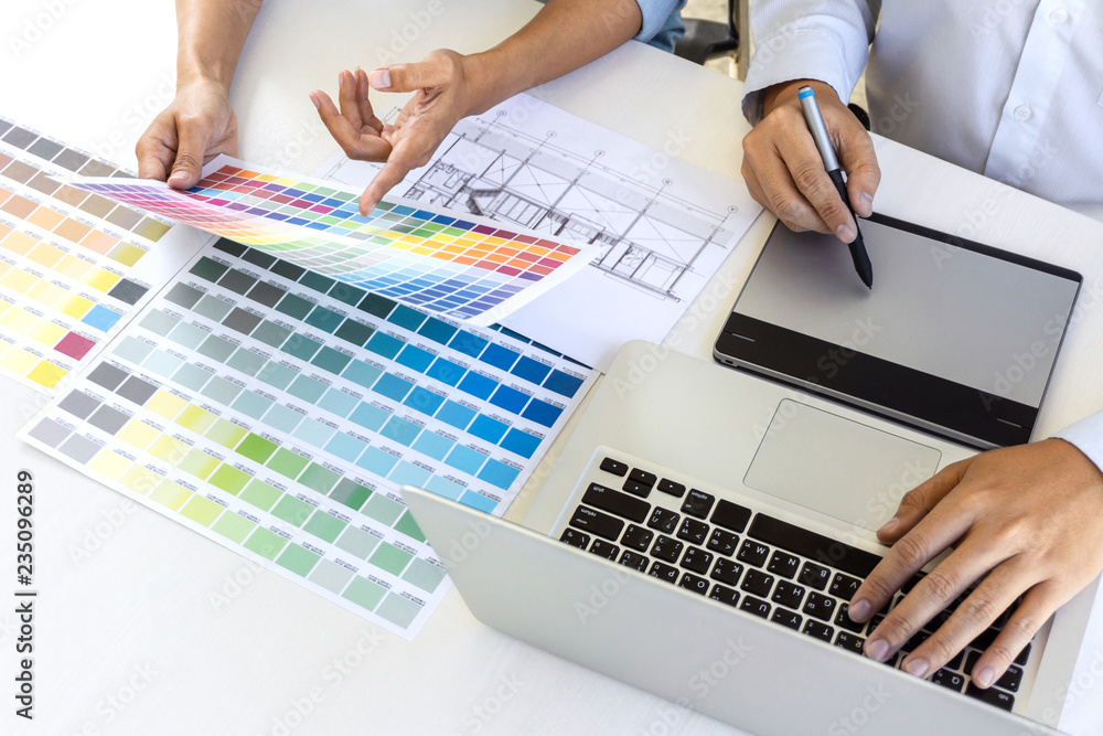 Fototapete team of colleague graphic designer drawing and retouching image on graphics tablet and choose color 
