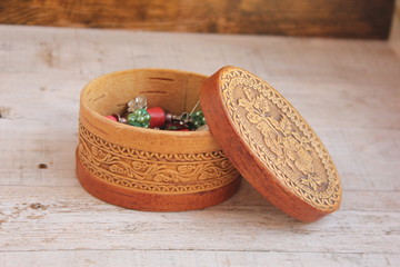 Oval-shaped birch bark box with handcrafted jewelry made from natural stones. Beautiful jewelry in a beautiful jewelry box.