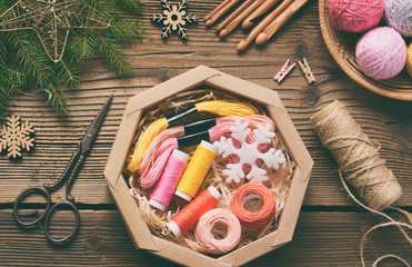 Gift wrapping. Present for the needlewoman - thread, floss, needles, hook, cotton yarn. Composition...