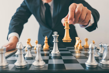 Businessman leadership playing chess and thinking strategy plan about crash overthrow the opposite team and development analyze for successful of corporate