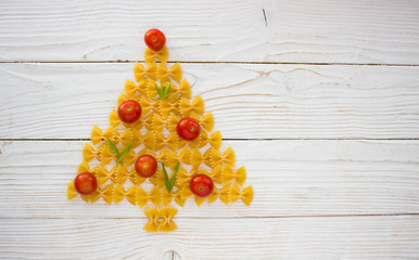 christmas ang new year tree made from pasta and tomatoes on white background free space for text - holidays, winter, celebration,  Christmas and  new year concept