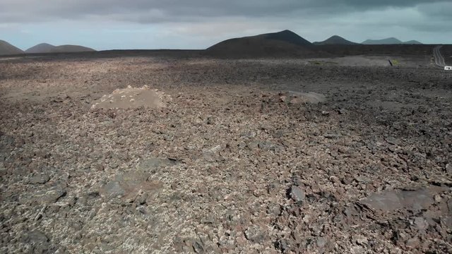 Pull back and panning up drone shot of a volcanic landscape