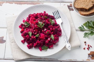 Fresh homemade Beetroot salad Vinaigrette in a white bowl. Traditional Russian food.